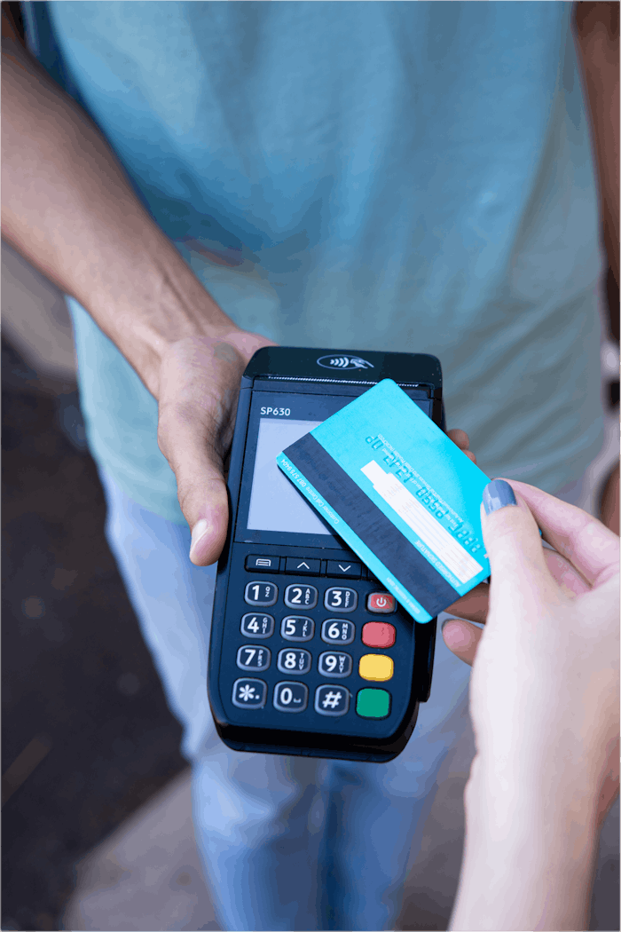 services-04 Close-up of hands performing contactless payment with credit card in Durban, South Africa.